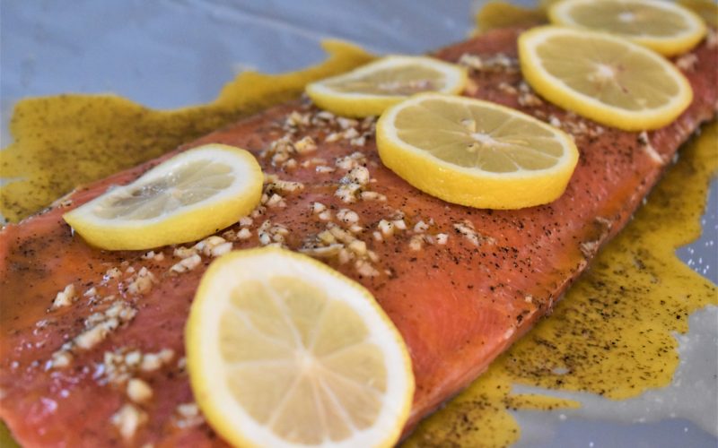 Photo of uncooked salmon with garlic and lemon and butter